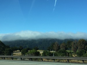 The clouds hang just over the mountain side creating a amazing view - Tech Break Blog